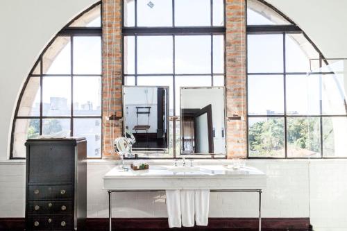 a bathroom with a sink and a large window at Factoria Hotel in Asuncion