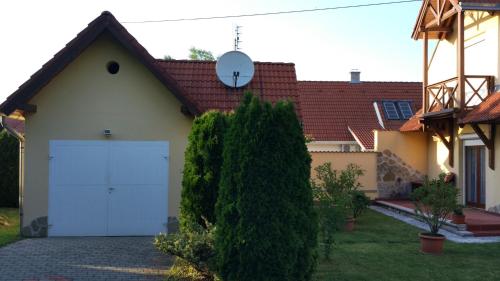 a house with a white garage with a red roof at Anna villa in Lenti