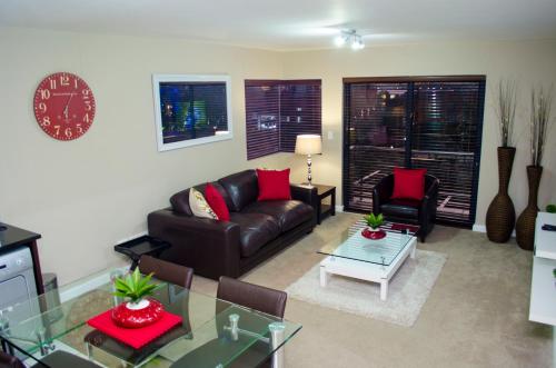 a living room with a couch and a table at Knightsbridge Luxury Apartments in Cape Town