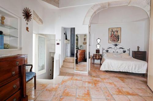 a bedroom with a bed and a staircase in it at La Chicca di C.Cavour in Ostuni