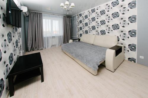 a bedroom with a bed and a tv in it at City Center Apartment on Pochtovy 4 in Orenburg