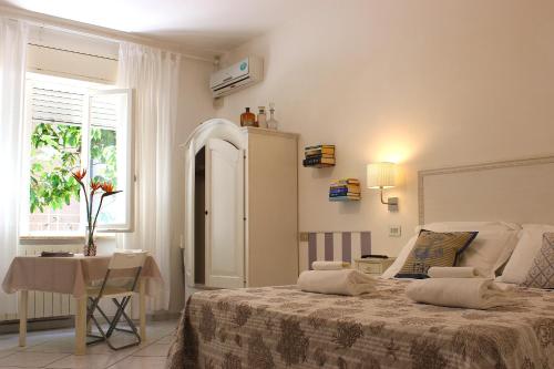 a bedroom with a bed and a table and a window at Soggiorno Tagliaferro in Marciana Marina