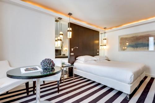 a hotel room with two beds and a table at Le A in Paris