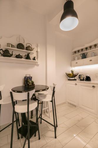 a kitchen with a table and chairs in a room at Apartment Sunrise in Hydra