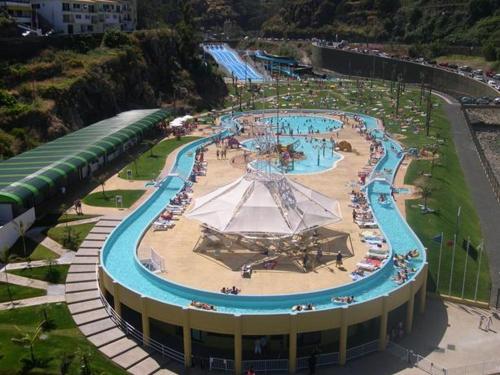 a large water park with a large swimming pool at Sweet Home for Holidays in Machico