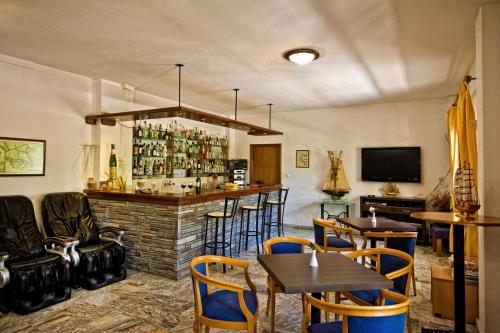 a bar in a restaurant with tables and chairs at Sunset Hotel in Ouranoupoli