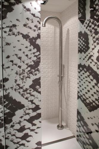 a shower stall in a bathroom with a shower at Hotel Manna in Nijmegen