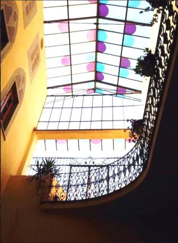 a view of a spiral staircase with a stained glass window at Appartamento Ernesto in Pistoia