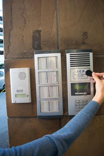 a person is manipulating a pay phone on a table at Snug Studio in the heart of the city in Auckland