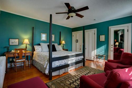 a bedroom with a bed and a ceiling fan at Brown Street Inn Bed and Breakfast in Iowa City