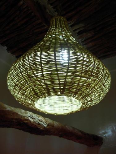 a large wicker light hanging from a ceiling at Kasbah Tigmi N'Oufella in Telouet