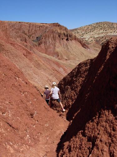 two people walking on a dirt hill in the desert at Kasbah Tigmi N'Oufella in Telouet
