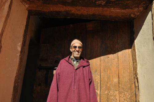 a man standing in front of a wooden door at Kasbah Tigmi N'Oufella in Telouet