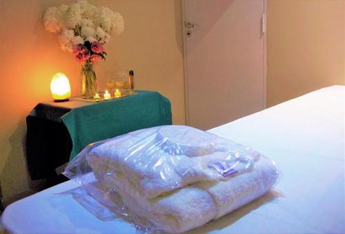 a plastic bag sitting on a bed next to a table at Kitek Hotel Boutique in Mendoza