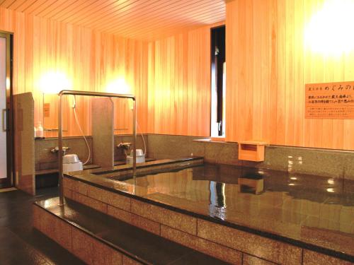 a large bathroom with a sink and a mirror at Yamagata Nanokamachi Washington Hotel in Yamagata