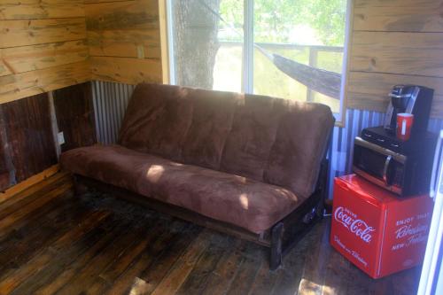 a brown leather couch sitting in a room at Hawk's Rest in Oakhurst