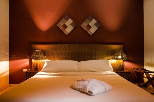 a bedroom with a bed with a dress on it at Hotel Vistalmar in Manta