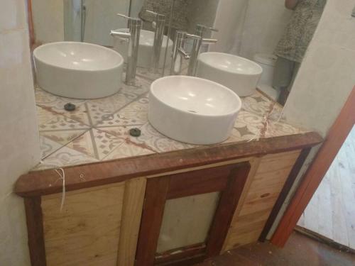 two sinks on top of a counter in a bathroom at Posada la Piedra in Constitución