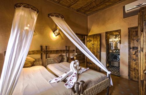 a bedroom with a large bed and a large window at Hotel Kasbah Le Mirage & Spa in Marrakech