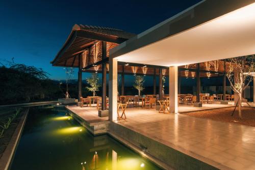 a villa with a pool at night at The Palmyrah House in Mannar