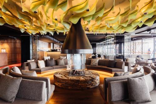 a lobby with couches and a fireplace in the middle at MACq 01 Hotel in Hobart