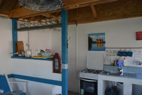 a small kitchen with a stove and a sink at Sailors Guest House Jurilovca in Jurilovca