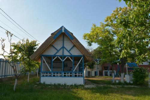 a small blue and white building with a roof at Sailors Guest House Jurilovca in Jurilovca