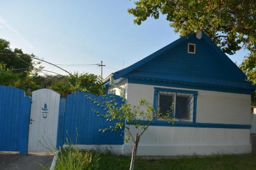 a blue and white house with a blue fence at Sailors Guest House Jurilovca in Jurilovca