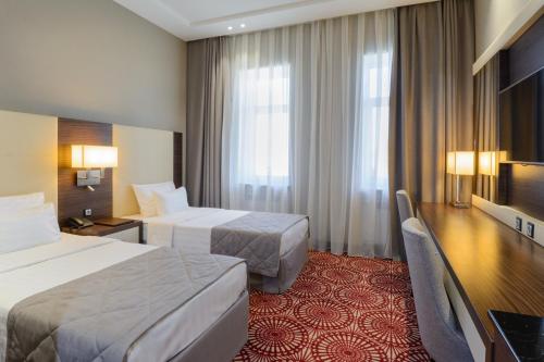 Postel nebo postele na pokoji v ubytování Hotel Senator