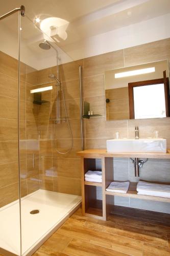 a bathroom with a sink and a shower at Hôtel Serenada in Algajola