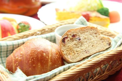 a basket with two pieces of bread in it at Pension Angelica in Minami Aso