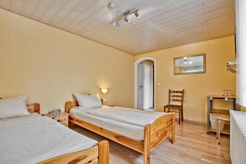 a bedroom with two beds and a desk in it at Landgasthaus Kreuz beim Tom in Rastatt