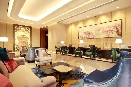 a hotel lobby with a waiting area with chairs and tables at Grand Mayfull Taipei in Taipei