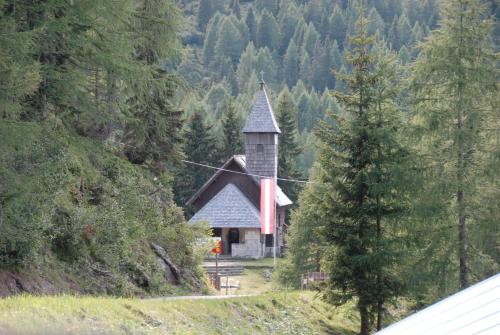 a small church in the middle of a forest at Hotel Berghof in Sonnenalpe Nassfeld