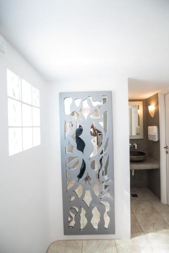a room with a glass door with a bunch of shoes at Hotel Spanelis in Mýkonos City