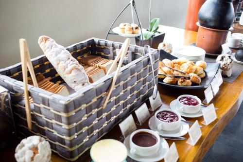 a table topped with bread and pastries and desserts at Ubud Wana Villa in Ubud