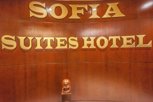 a sign for a santa claus hotel on a wall at Sofia Hotel in Amman