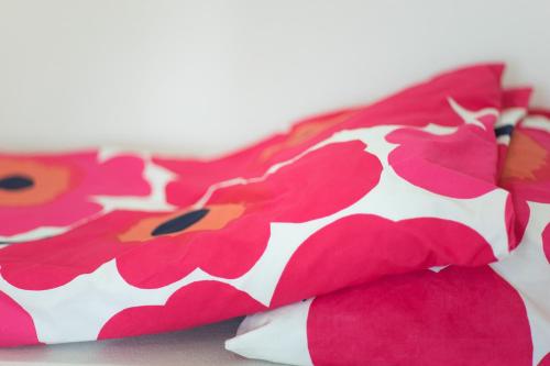 a pile of red and white pillows on a bed at Amazing Penthouse old town in Sarajevo