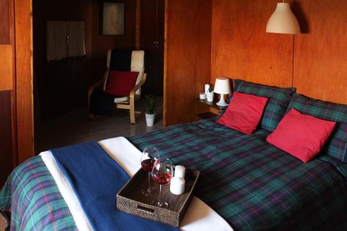 a bedroom with a bed with a tray on it at Millhousedune in Cepães