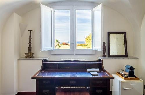 a desk in a room with a window at L' Hôtellerie Easy Suites in Palermo