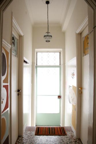 a hallway with a green door and a window at Sun sto Spiti in Athens