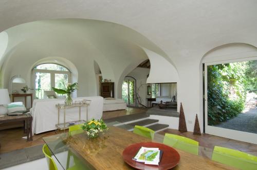 a living room with a table and a couch at Villa Edera in Viagrande