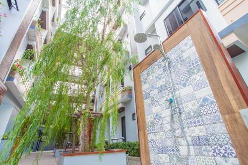 a door to a building with a tree outside at New Siam Palace Ville Hotel in Bangkok