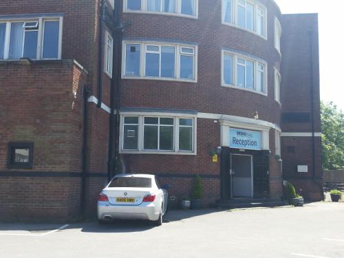 a white car parked in front of a brick building at The Bridge Hotel in Scunthorpe