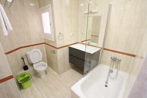 a bathroom with a toilet and a sink and a shower at For a Stay Sant Jordi in Salou