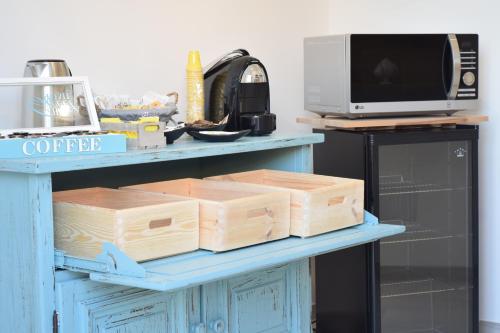 a table with boxes on it with a microwave at B&B La Focara in Novoli