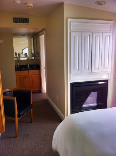 a bedroom with a bed and a fireplace at Benchmark Inn in Provincetown