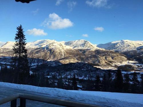 a view of a mountain range with snow covered mountains at Skarsnuten Panorama 14 in Hemsedal