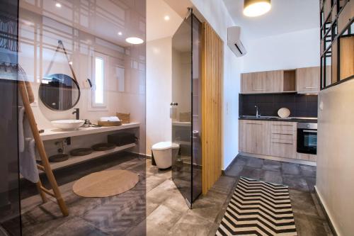 two images of a bathroom with a sink and a toilet at Len Art Selected Studios in Faliraki