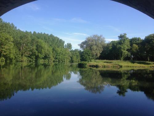 a view of a river from under a bridge at La Rive Chambre d hôtes The Riverside Retreat in Jarnac